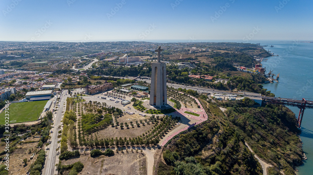 Aerial. Panorama from sky, a 25 de Abril Bridge and a statue of Jesus Christ. Lisbon.