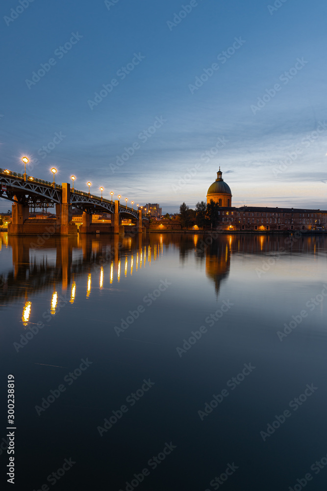 View of Chapelle Saint-Joseph and bridge Pont Saint-Pierre from the square Place Saint-Pierre at Sunset in Toulouse France