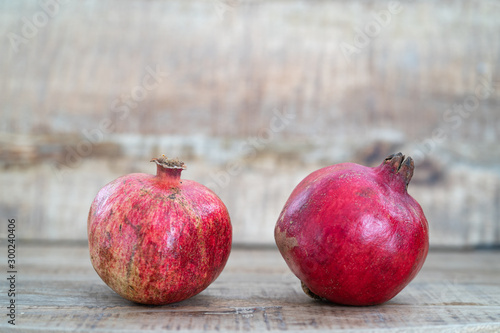 Red pomegranate on a background of natural wood. Parts of pomegranate.