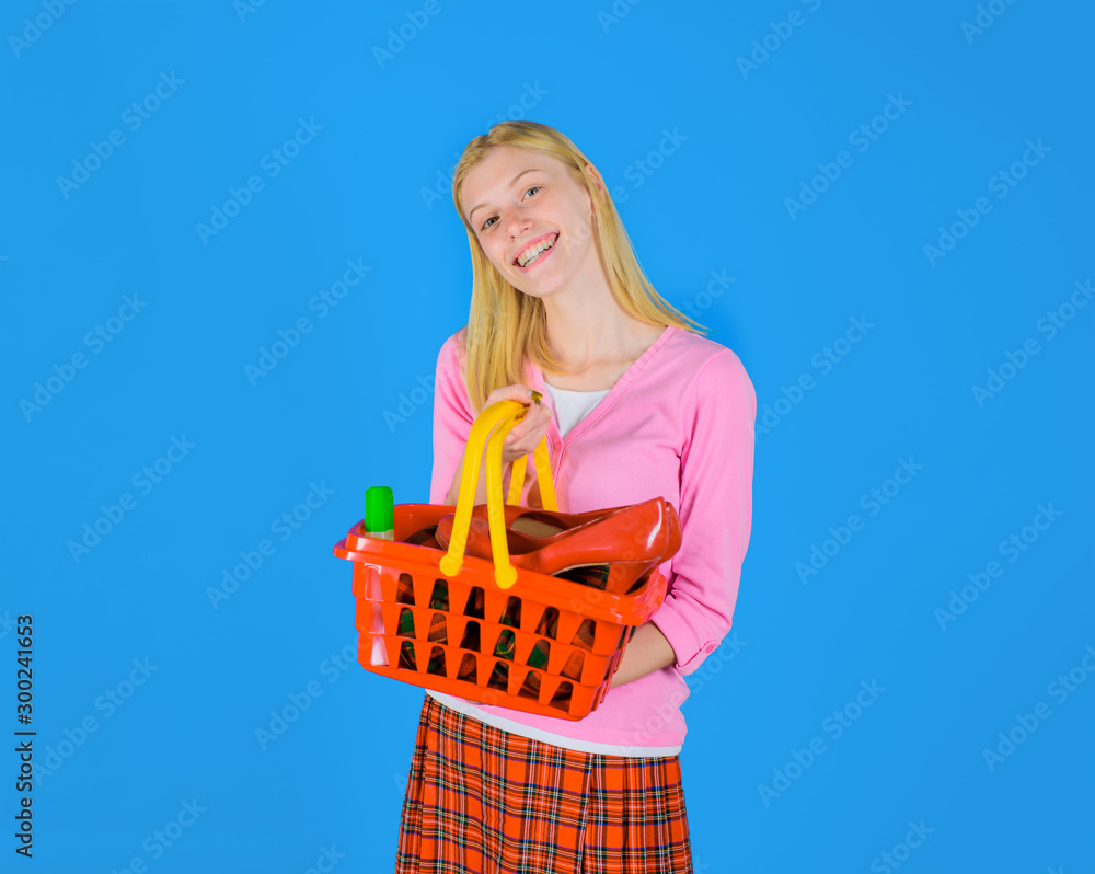 Fashion girl with shopping basket. Happy girl on shopping. Smiling woman shopping at supermarket, store. Woman with basket in shop. Sale. Discount. Black friday. Woman with shopping cart. Supermarket.