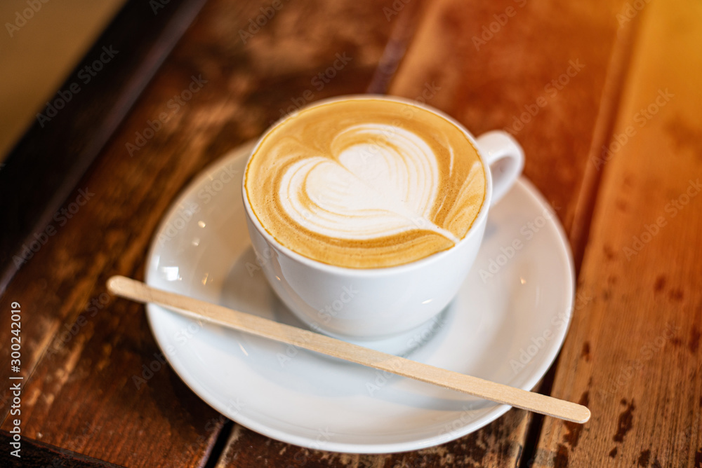 Fototapeta coffee cup latte art on wooden background