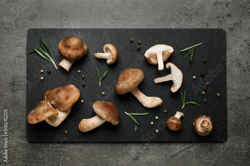 Flat lay composition with fresh wild mushrooms on grey table