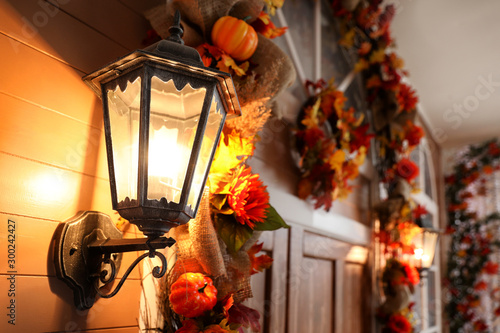 Fotografie House decorated for traditional autumn holidays, focus on vintage outdoor light
