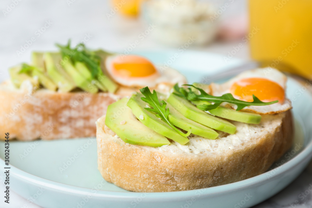 Plate of delicious avocado sandwiches on table, closeup