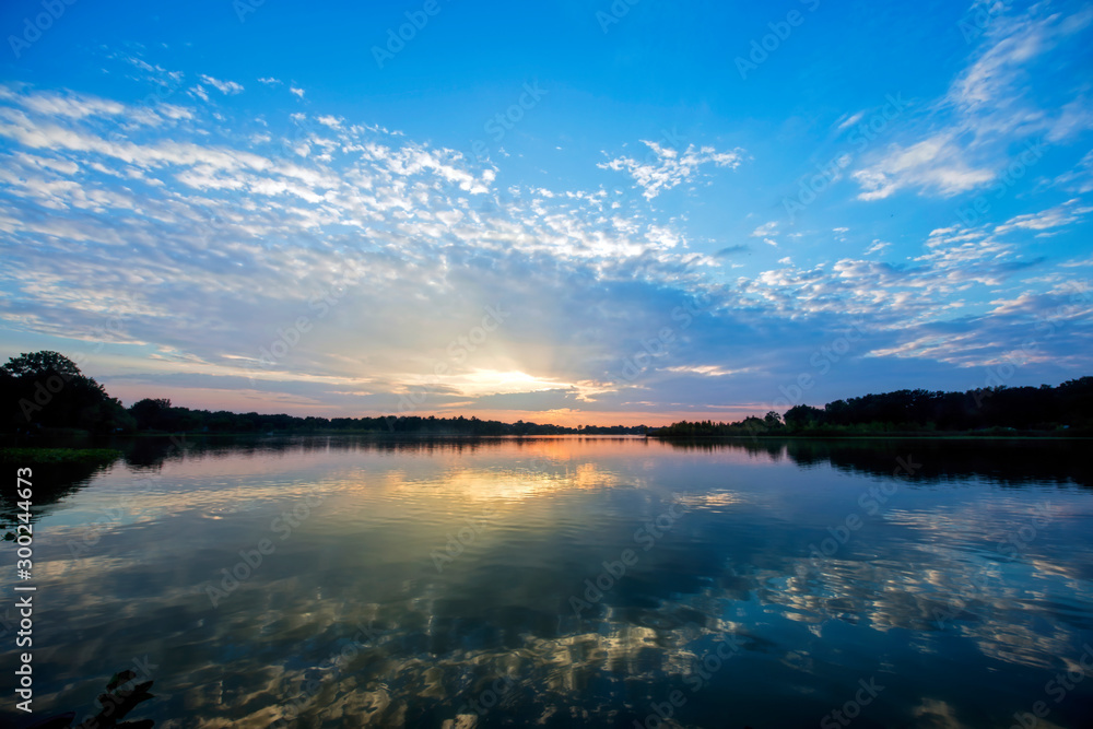 Sunset over Quiet Water with Sunbeams Sunset over Quiet Water with Sunbeams