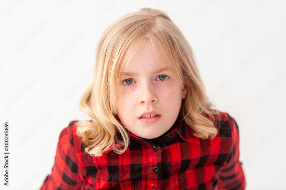 Headshot of a pretty blonde preteen girl with neutral expression on a white studio background Headshot of a pretty blonde preteen girl with neutral expression on a white studio background