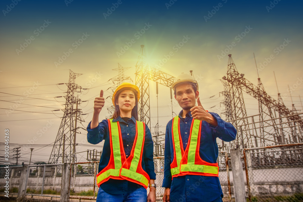 Two Engineer Thump up Success project Power plant  System Sunlight Background,Technician Safety suit Hardhat in Construction industrial