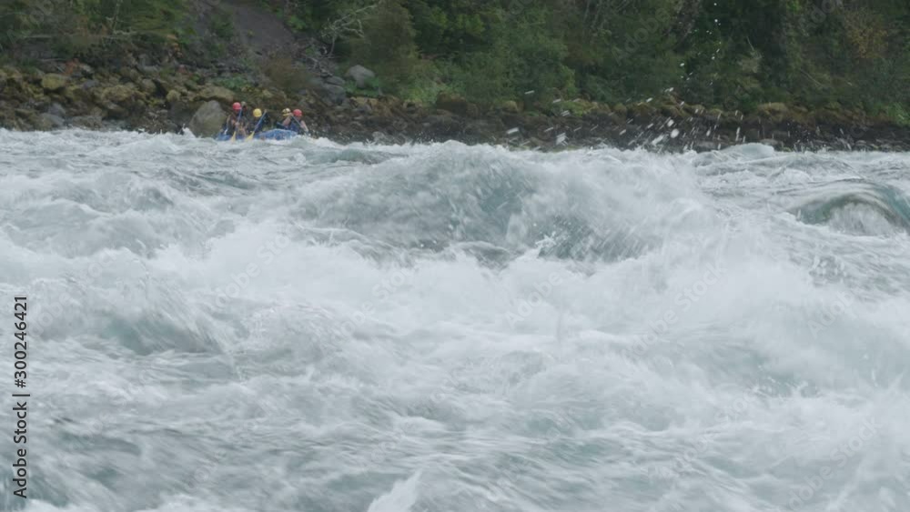 Whitewater rafters paddling through rapids on a river in Patagonia Chile Whitewater rafters paddling through rapids on a river in Patagonia Chile