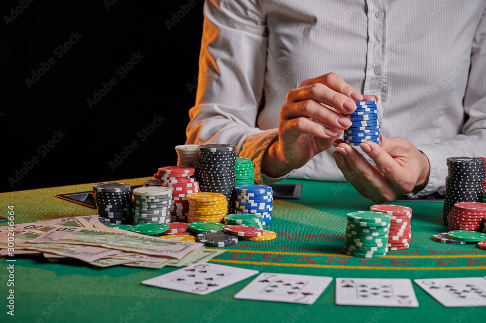 The croupier at the gaming table in the casino, raises bets with chips. Gaming business black jack, poker. With space for design. The croupier at the gaming table in the casino, raises bets with chips. Gaming business black jack, poker. With space for design.
