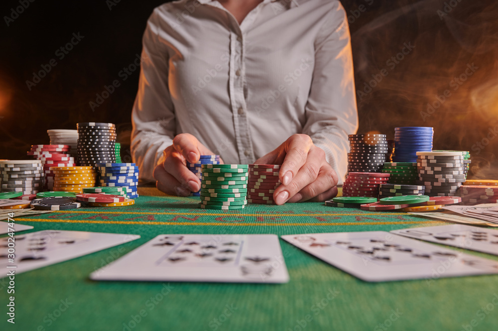 croupier accepts bets at casino, poker table, chips, dollars croupier accepts bets at casino, poker table, chips, dollars