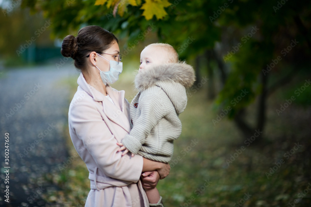 mother in medical mask and a baby mother in medical mask and a baby