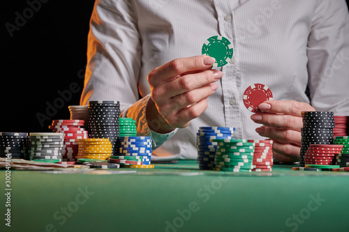 croupier in a casino accepts or raises bets with chips. money, poker, success