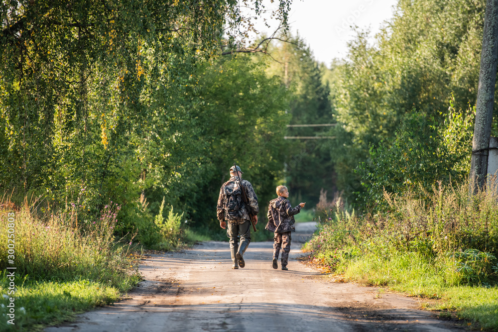 Obraz premium father pointing and guiding son on first deer hunt