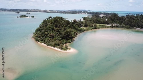 4K空撮動画　沖縄の美しいエメラルドグリーンの海と白い砂浜
4K aerial of flying over a beautiful Emerald green sea and white sand beach,  Haneji-Naikai Inland Sea, Okinawa, Japan photo