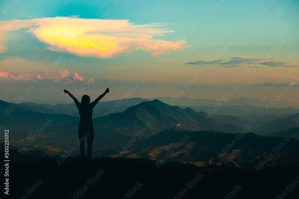 silhouette of woman on mountain top over sky and sun light background,business, success, leadership, achievement and people concept