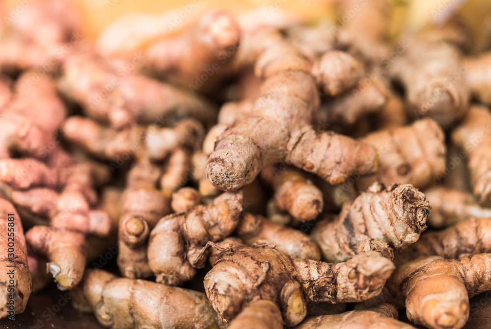 Turmeric roots on display at a farmers market, selective focus Turmeric roots on display at a farmers market, selective focus