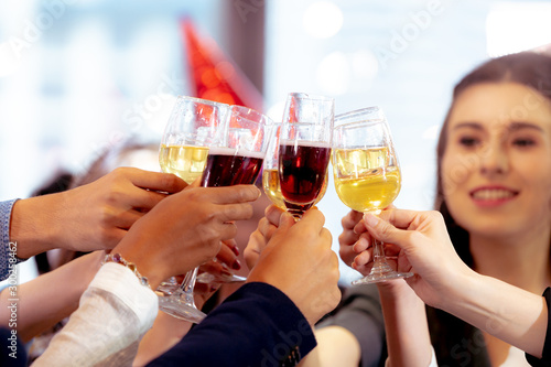Clinking Glasses of Champagne or Wine. Group of Business People Celebrating New Year at Office party.