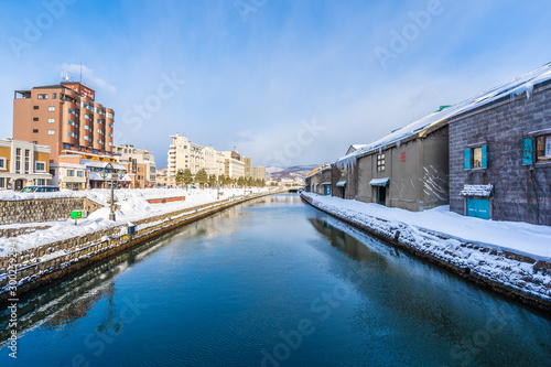 Beautiful landscape and cityscape of Otaru canal river in winter and snow season © siraphol