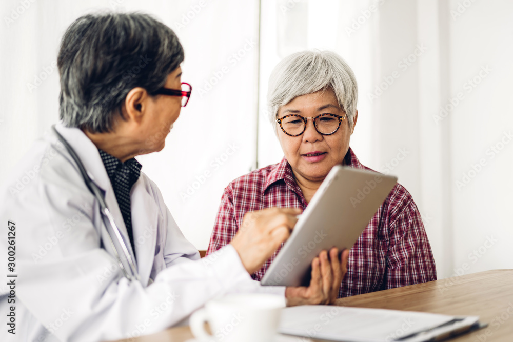 Doctor consulting and check up information with senior woman in hospital.elderly woman has sick.healthcare and medicine Doctor consulting and check up information with senior woman in hospital.elderly woman has sick.healthcare and medicine