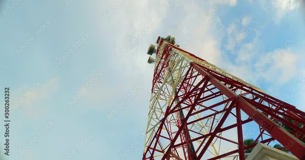 Tall communication antenna in remote tropical island of Jamaica on cloudy sky background, copy text Tall communication antenna in remote tropical island of Jamaica on cloudy sky background, copy text