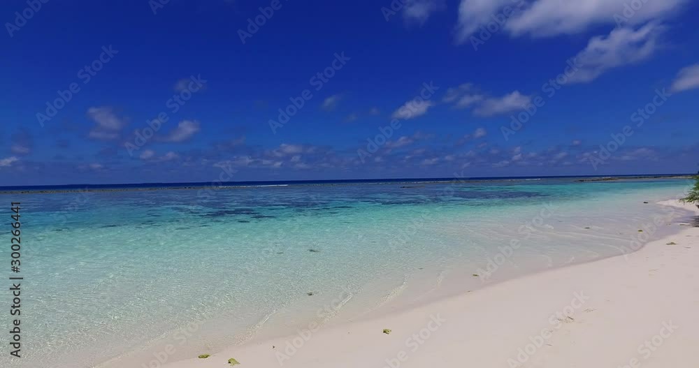 Light breeze waving calm lagoon surface on a hot midday of exotic white beach, blue sky with stunning clouds in Indonesia Light breeze waving calm lagoon surface on a hot midday of exotic white beach, blue sky with stunning clouds in Indonesia