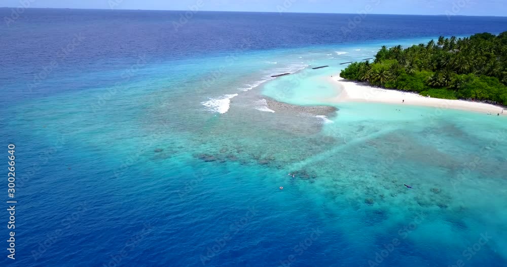 Bright blue turquoise lagoon around tropical island bay splashed by white waves on a summer day in Philippines Bright blue turquoise lagoon around tropical island bay splashed by white waves on a summer day in Philippines