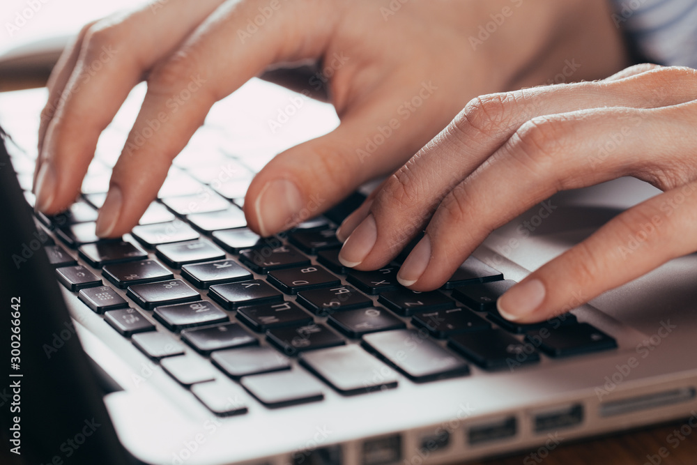 Woman working at home office hand on keyboard close up Woman working at home office hand on keyboard close up