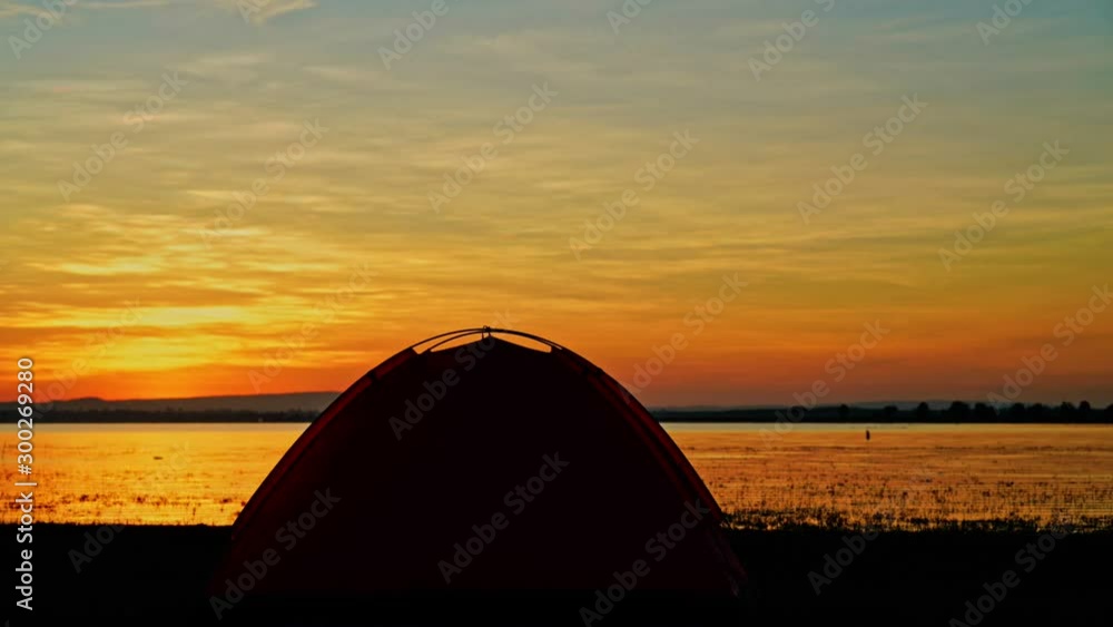 time lapse of camping tent in the morning against sunlight beside the sea with nature background time lapse of camping tent in the morning against sunlight beside the sea with nature background