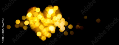 Holiday bokeh golden lights Defocused shiny heart shape photo