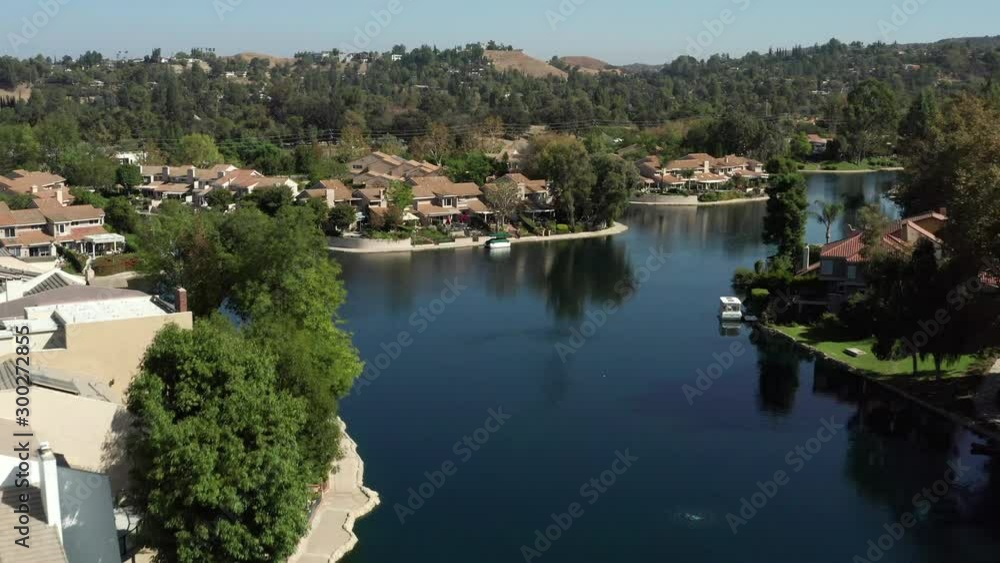Drone flyover Calabasas lake and homes of rich and famous, daytime