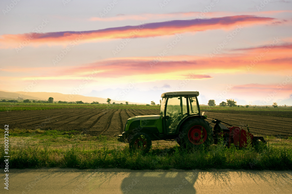 Fototapeta premium Plowed land and tractor