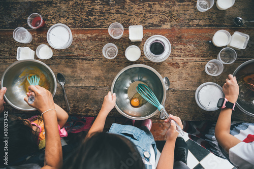 Group of kids are preparing the bakery in the kitchen .Children learning to cooking cookies
