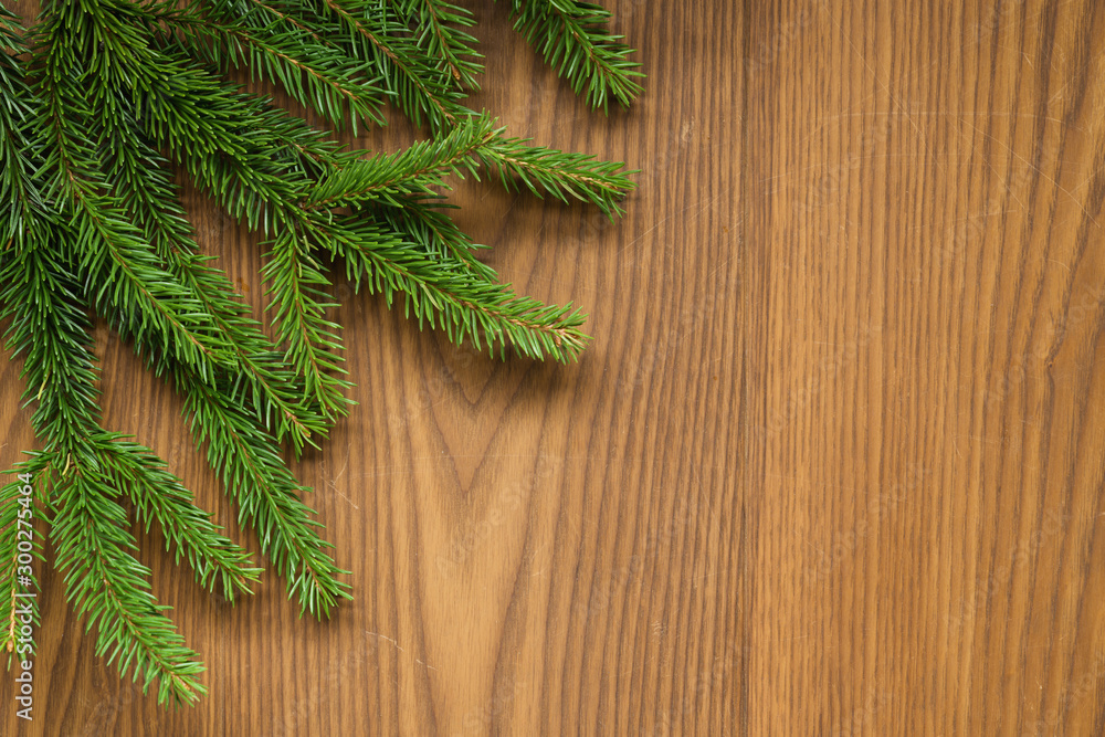 Flat lay christmas background with spruce twigs on ash wood surface Flat lay christmas background with spruce twigs on ash wood surface