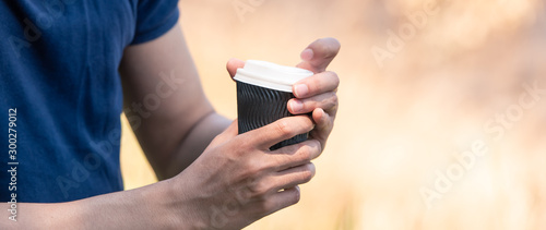Coffee cup in young hands