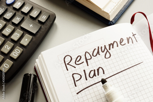Conceptual hand written text showing repayment plan photo
