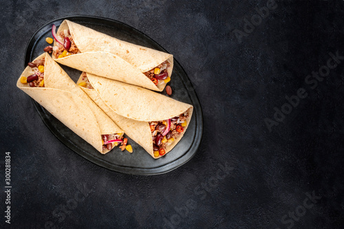 Photography Burrito sandwich wraps, shot from above on a black background