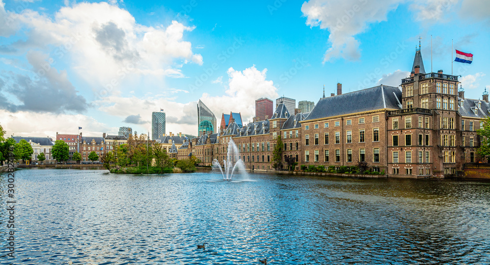 Binnenhof palace complex with pond and fountain in the foreground and business district in the background, The Hague, Netherlands
