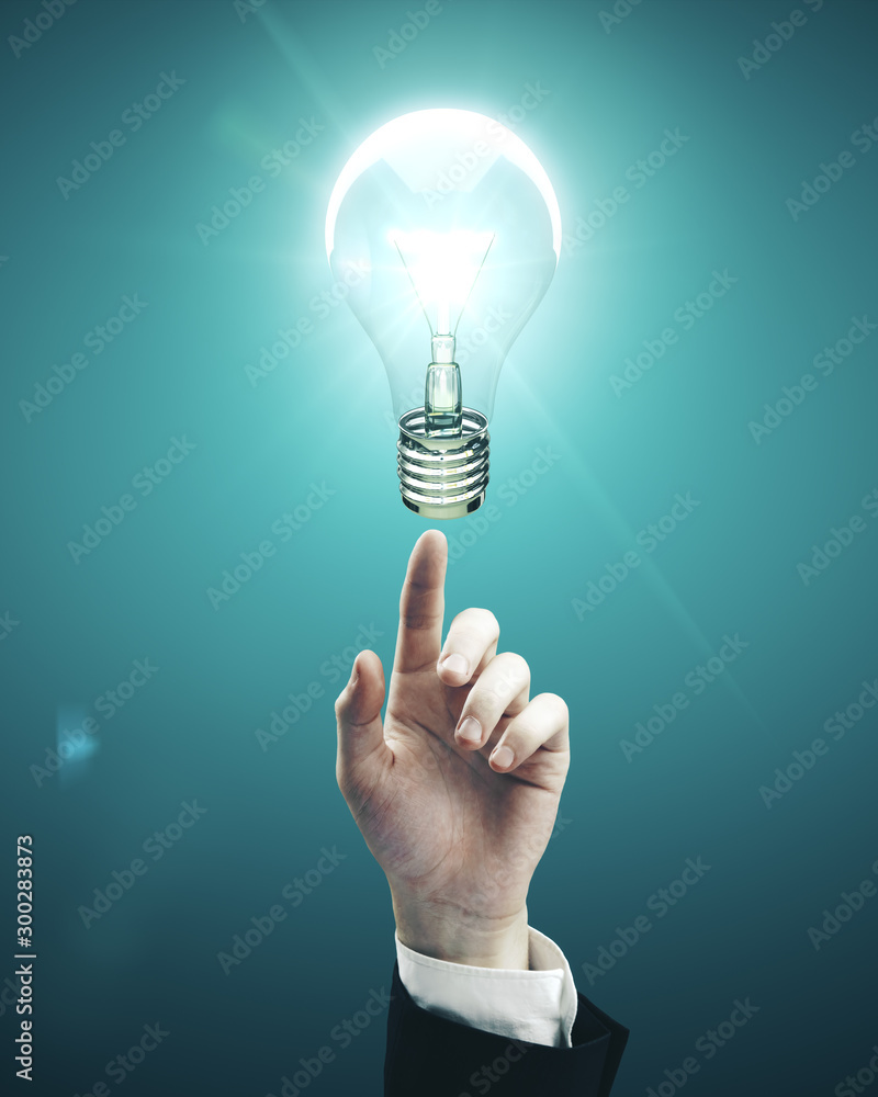 hand pointing to light bulb hand pointing to light bulb