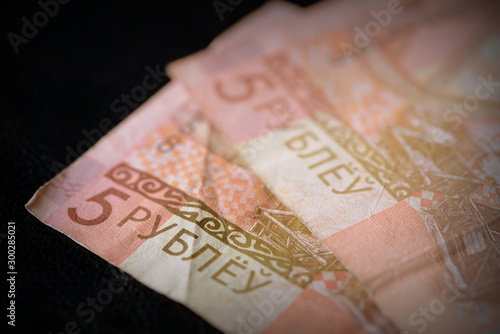 Outdated Belarusian five rubles banknotes on a dark background close up. Retro style