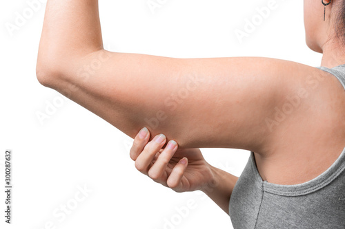 Asian woman pinching arm fat flabby skin isoloate on white background, with clipping path.