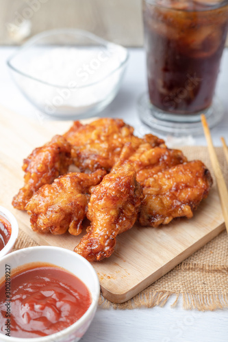 Hot and spicy Korean barbeque fried chicken on wood cutting board