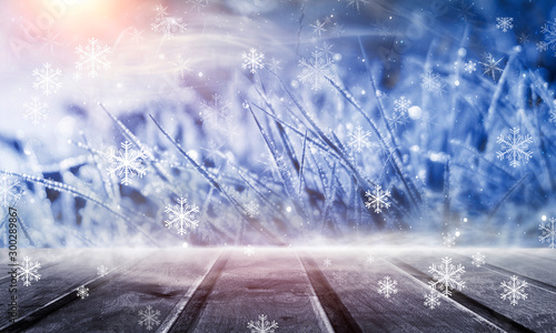 Winter wooden table. Forest winter landscape, snowflakes, sunlight.