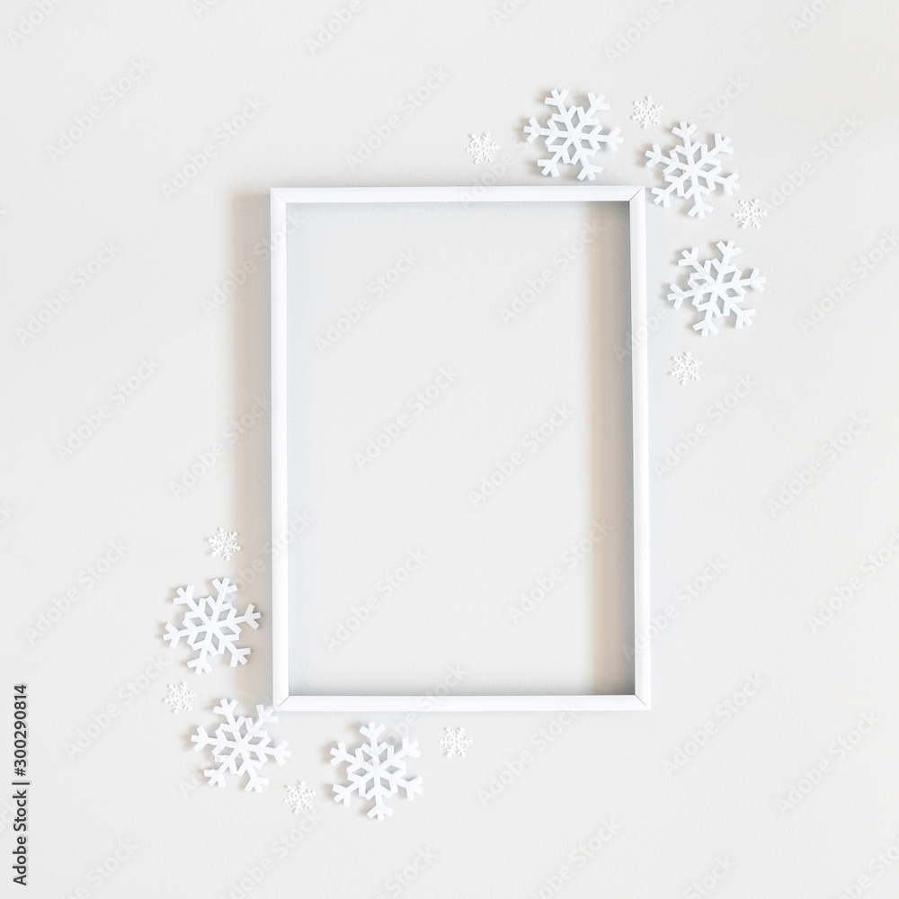 Christmas composition. Photo frame, snowflakes on pastel gray background. Christmas, winter, new year concept. Flat lay, top view, copy space, sguare - obrazy, fototapety, plakaty 