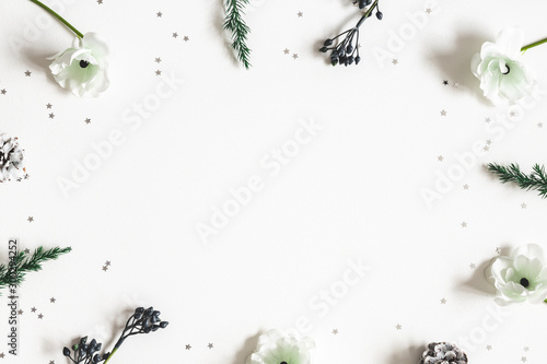 Christmas composition. Frame made of winter plants on white background. Christmas, winter concept. Flat lay, top view, copy space