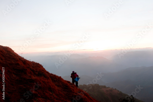 tourist at the top of the mountain During sunset