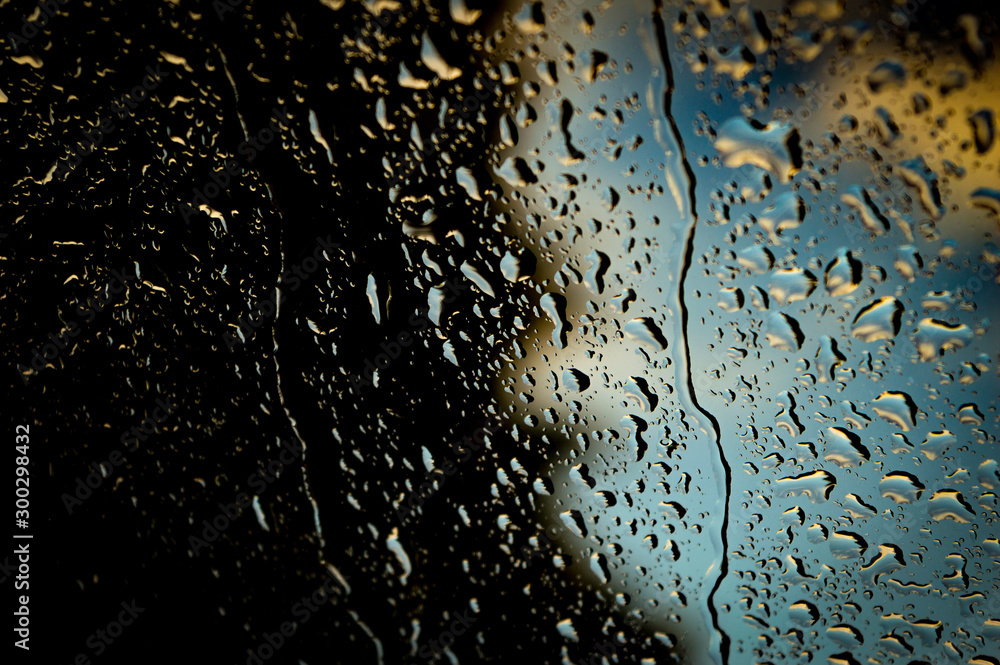 water drops on a glass car in rain water drops on a glass car in rain