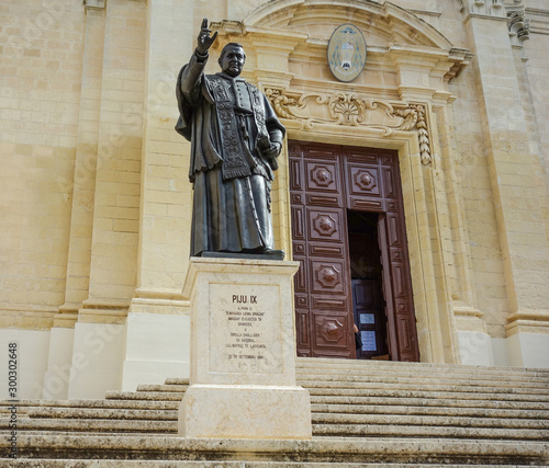 Statue of Pope Pius IX (Giovanni Maria Mastai Ferretti) at the entrance of the Cathedral of the Assumption, a Roman Catholic cathedral in the Cittadella of Victoria in Gozo, Malta photo