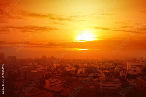 Heatwave on the city with the glowing sun background photo