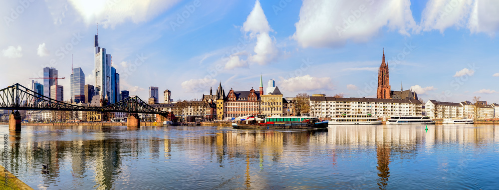 Wide color panorama of the city of Frankfurt am Main,skyscrapers,cathedral,sky clouds, river,bridge,cranes,boats,on s sunny day - obrazy, fototapety, plakaty 