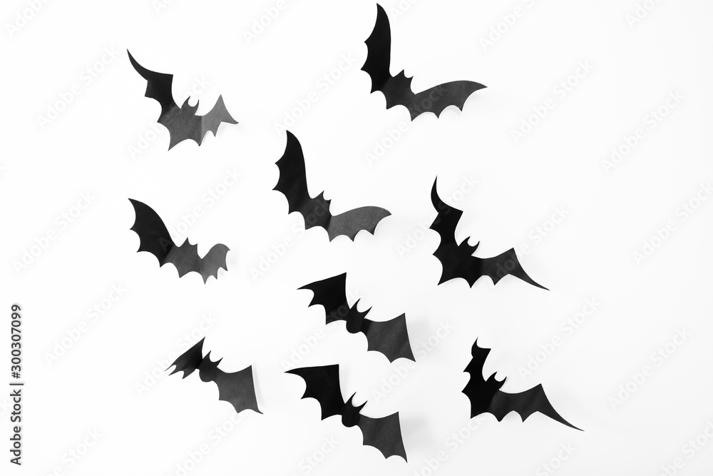 Fototapeta premium Halloween background. bats decoration pattern on white background. Top view of Halloween paper craft black bats. copy space